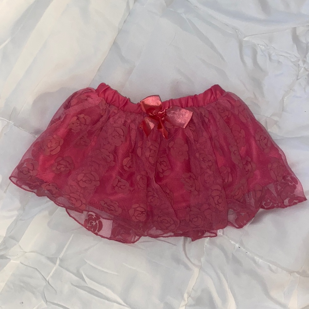 Five toddler, pink skirt with roses.